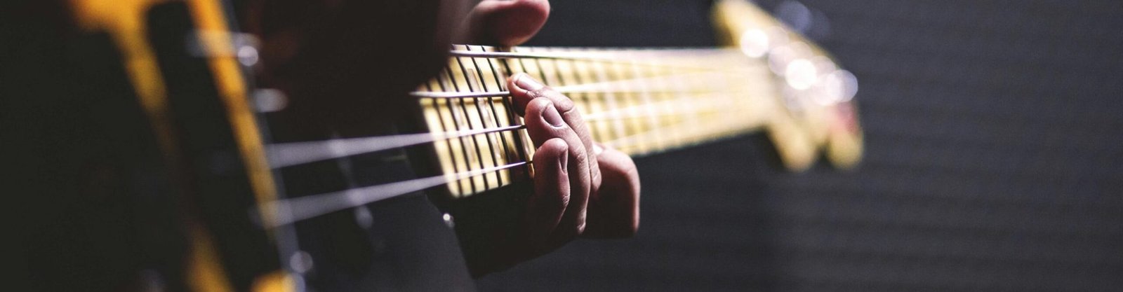 pexels-photo-96380-96380 Person Playing Sun Burst Electric Bass Guitar in Bokeh Photography